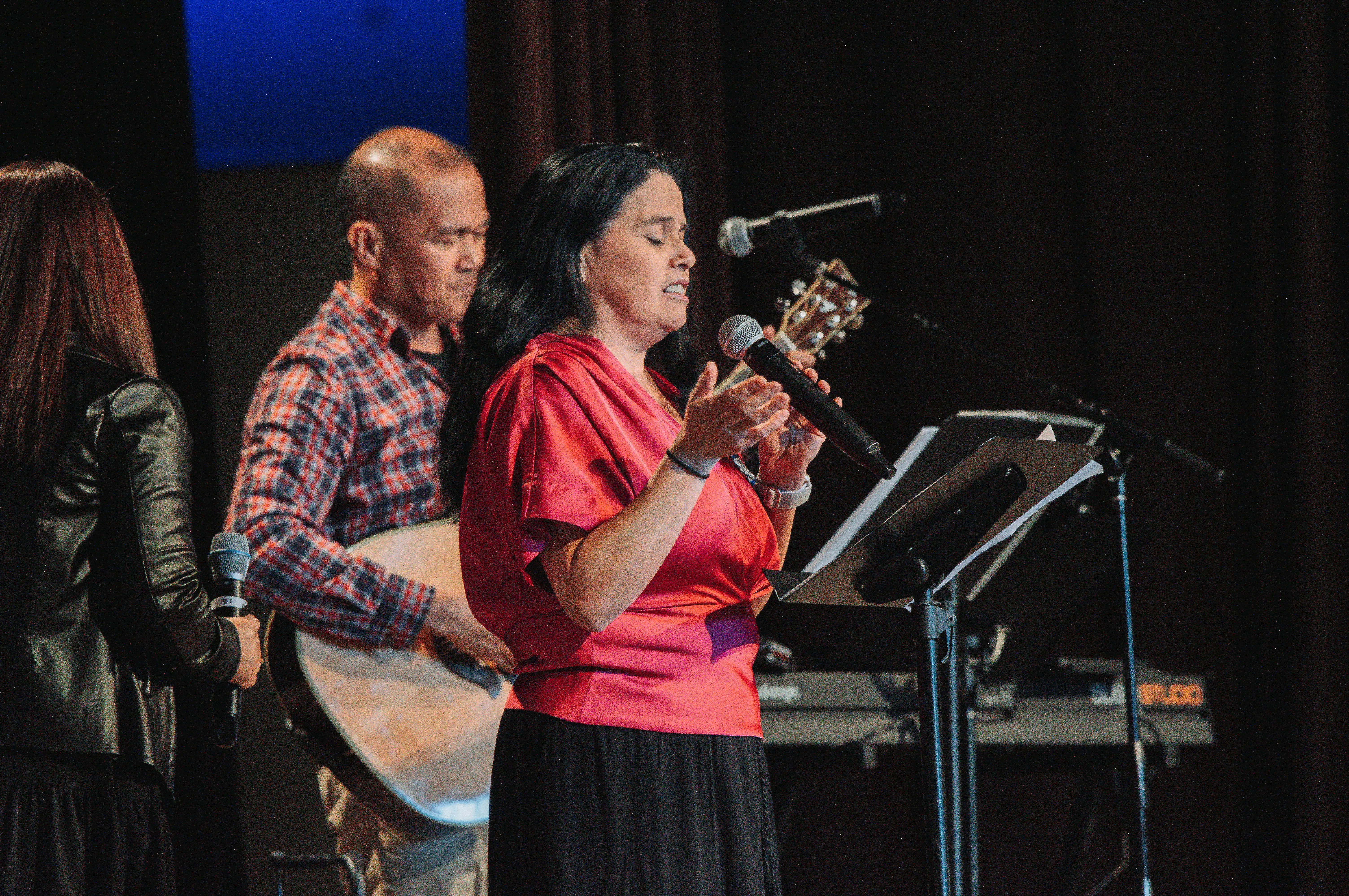 Worship team leading music on stage